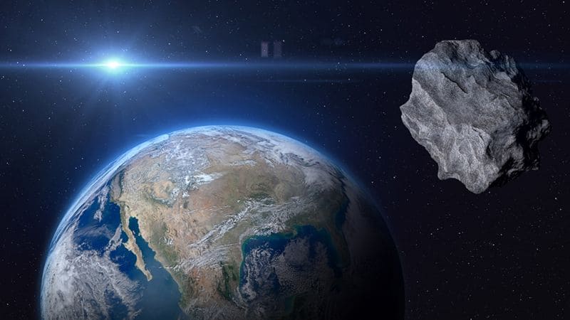 Ilustración digital de un asteroide pasando cerca de la Tierra